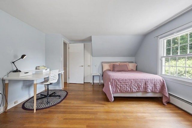 30 Brigham St, Hudson, MA 01749 - bedroom with light wood-style flooring, baseboard heating, and vaulted ceiling