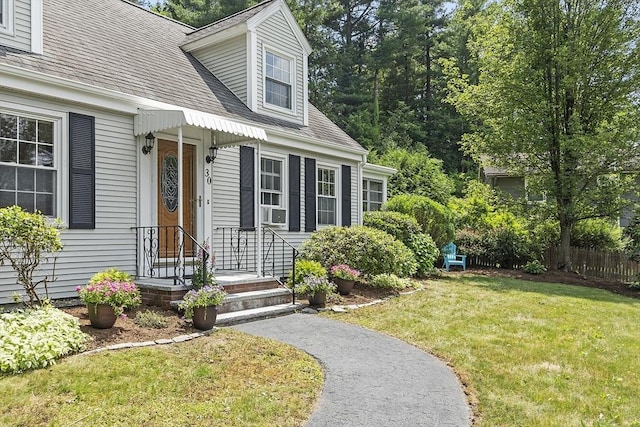 30 Brigham St, Hudson, MA 01749 - view of exterior entry with a lawn and a shingled roof