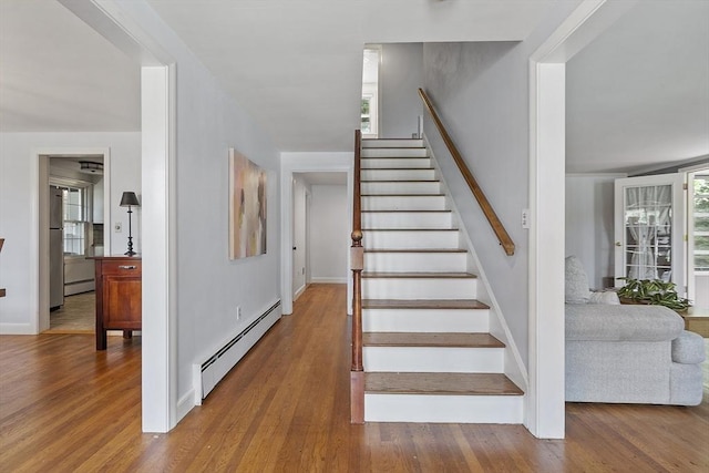 30 Brigham St, Hudson, MA 01749 - stairway with a baseboard heating unit and wood finished floors