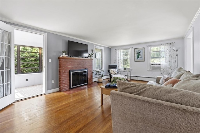 30 Brigham St, Hudson, MA 01749 - living area with crown molding, wood finished floors, a brick fireplace, a baseboard radiator, and cooling unit