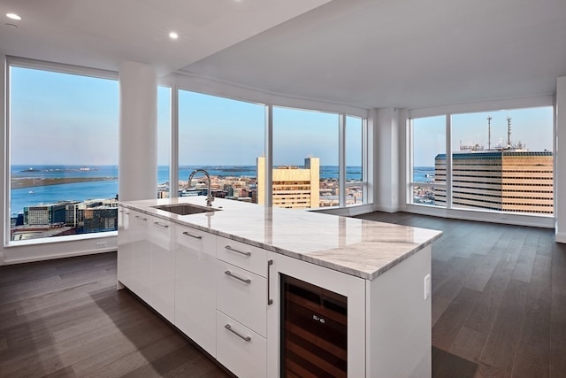 kitchen with beverage cooler, sink, dark hardwood / wood-style flooring, and white cabinetry