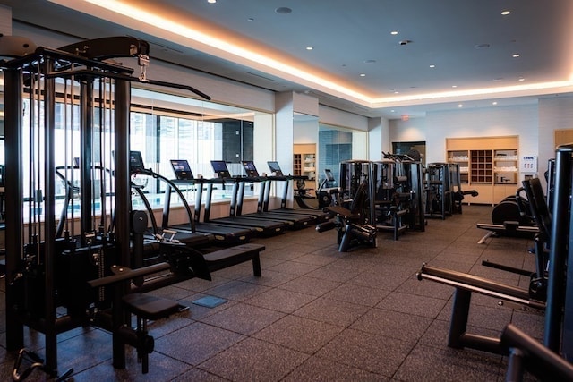 exercise room with a tray ceiling