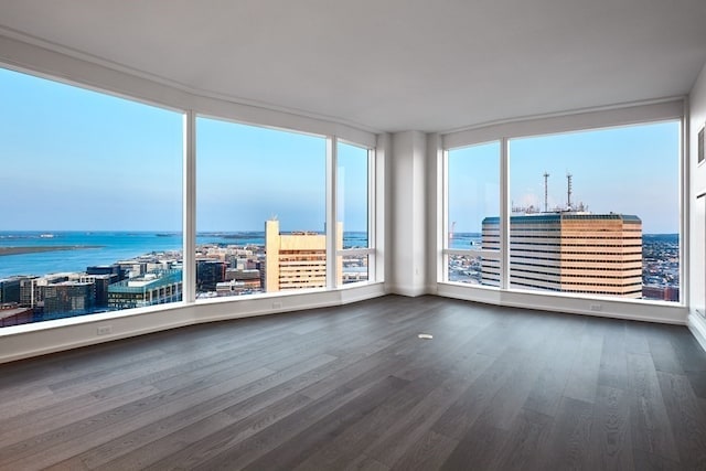 unfurnished sunroom featuring a water view