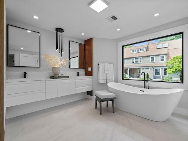 8 Wiswall Unit 8, Wellesley, MA 02482 - full bath featuring double vanity, a freestanding bath, baseboards, and recessed lighting