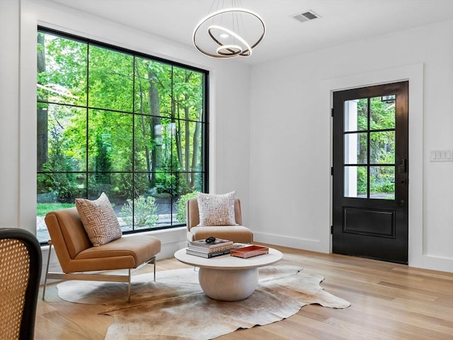 8 Wiswall Unit 8, Wellesley, MA 02482 - sitting room featuring a chandelier, healthy amount of natural light, light wood finished floors, and baseboards