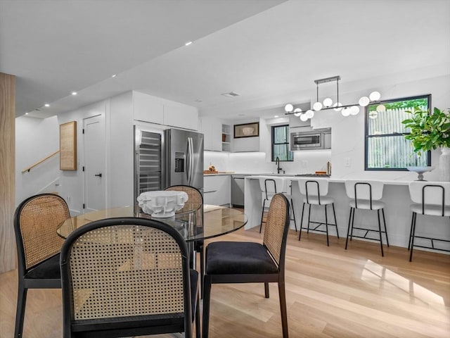 8 Wiswall Unit 8, Wellesley, MA 02482 - dining area featuring recessed lighting, light wood-style floors, a chandelier, and baseboards