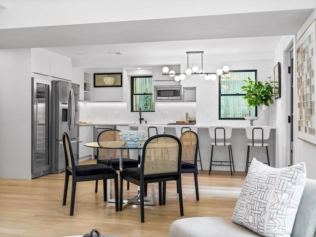 8 Wiswall Unit 8, Wellesley, MA 02482 - dining room with light wood-style floors and a chandelier