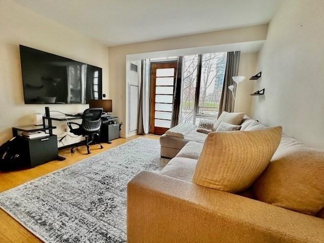 2 Earhart Unit 121, Cambridge, MA 02141 - living area featuring wood finished floors and an office area