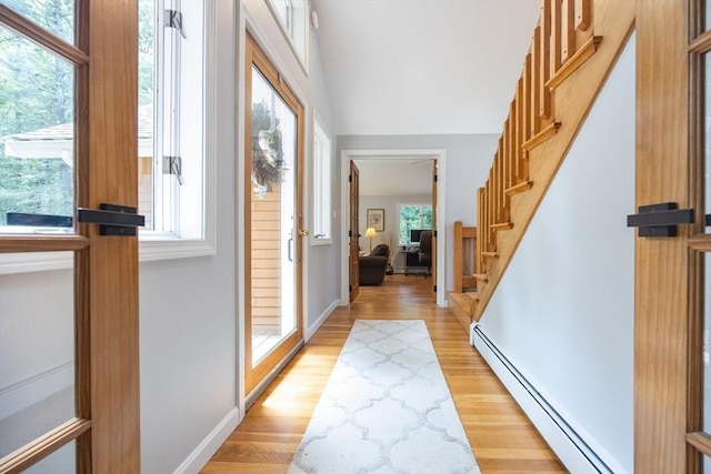 56 Burt St, Norton, MA 02766 - foyer featuring a baseboard heating unit, light wood-style floors, and stairway