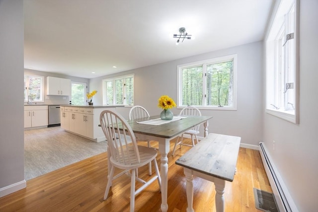 56 Burt St, Norton, MA 02766 - dining area with a baseboard heating unit, light wood finished floors, healthy amount of natural light, and recessed lighting