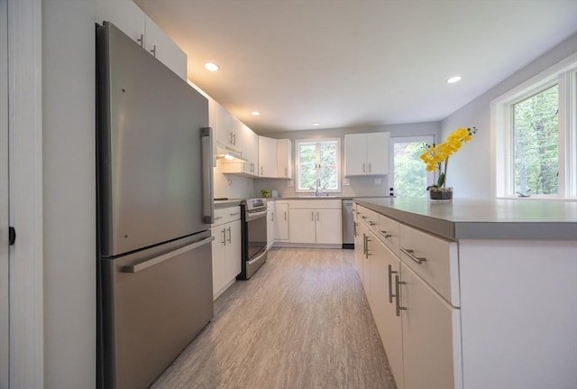 56 Burt St, Norton, MA 02766 - kitchen featuring stainless steel appliances, healthy amount of natural light, light wood-style flooring, recessed lighting, and white cabinets