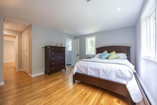 56 Burt St, Norton, MA 02766 - bedroom with attic access, light wood-type flooring, a baseboard radiator, and a baseboard heating unit