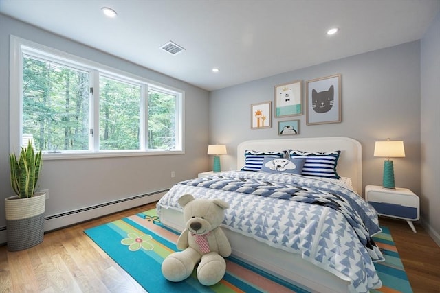 56 Burt St, Norton, MA 02766 - bedroom with a baseboard radiator, wood finished floors, and recessed lighting