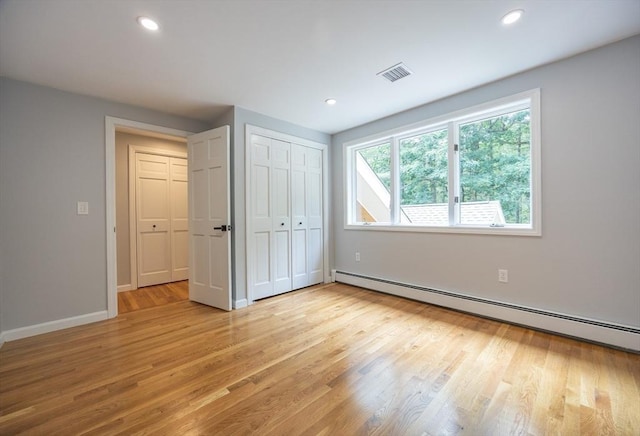 56 Burt St, Norton, MA 02766 - unfurnished bedroom with baseboard heating, light wood-type flooring, recessed lighting, and a closet