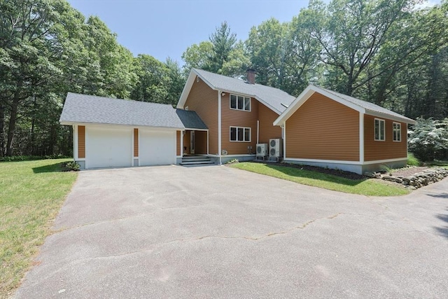 56 Burt St, Norton, MA 02766 - view of front of house featuring asphalt driveway, an attached garage, and a front lawn