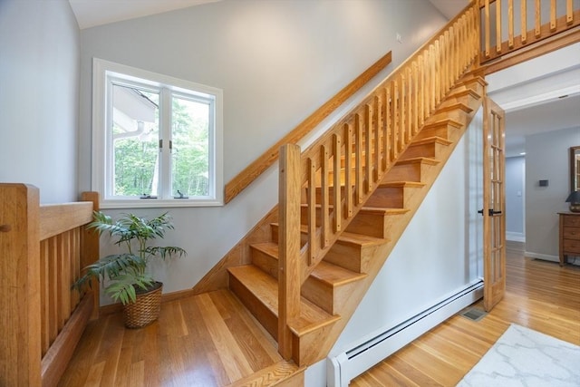 56 Burt St, Norton, MA 02766 - stairs with a baseboard radiator, wood finished floors, and vaulted ceiling