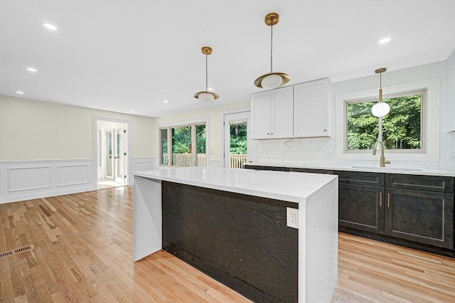 30 Twilight Dr, Foxboro, MA 02035 - kitchen featuring light countertops, light wood-style flooring, plenty of natural light, a wainscoted wall, and a decorative wall