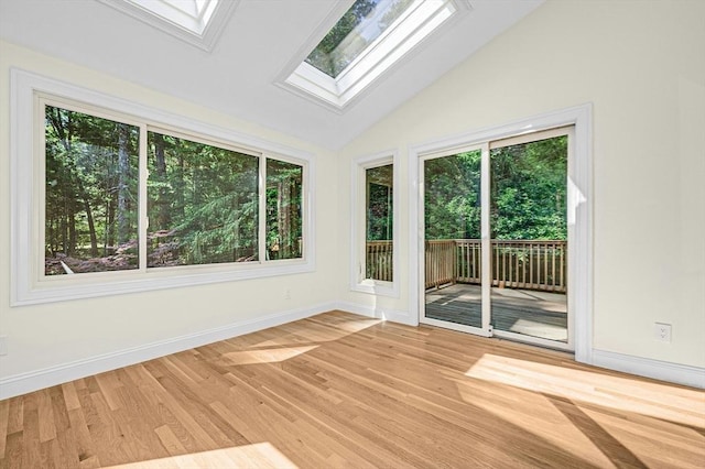 30 Twilight Dr, Foxboro, MA 02035 - unfurnished room featuring a skylight, plenty of natural light, lofted ceiling, and light wood-style flooring