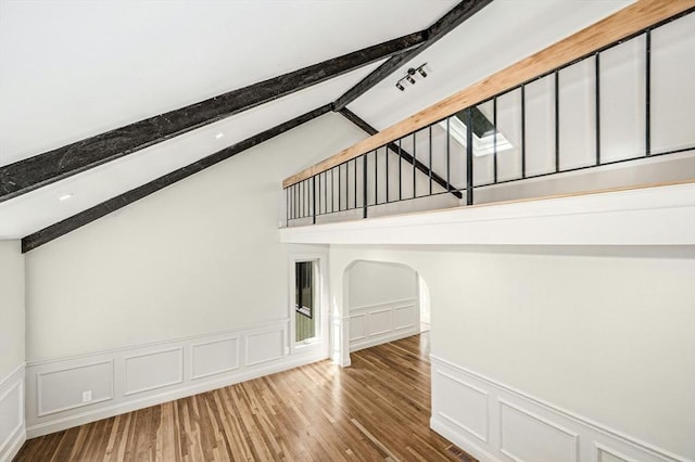 30 Twilight Dr, Foxboro, MA 02035 - unfurnished living room featuring a decorative wall, wood finished floors, wainscoting, and arched walkways