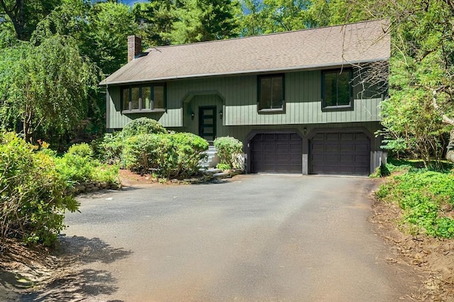 30 Twilight Dr, Foxboro, MA 02035 - raised ranch with an attached garage, asphalt driveway, a chimney, and roof with shingles
