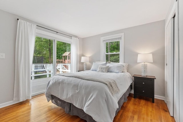 12 Billings St, Acton, MA 01720 - bedroom with multiple windows, access to exterior, baseboards, and light wood finished floors