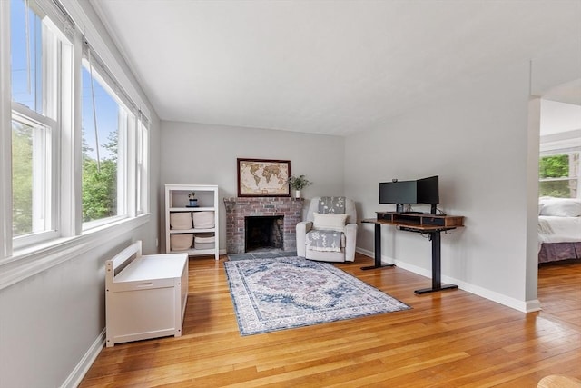 12 Billings St, Acton, MA 01720 - living room with light wood-style floors, baseboards, and a brick fireplace