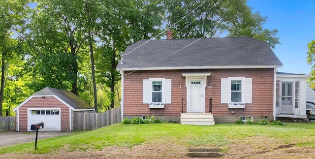 50 Wethersfield, Rowley, MA 01969 - view of front facade featuring a detached garage, an outbuilding, a chimney, a shingled roof, and driveway