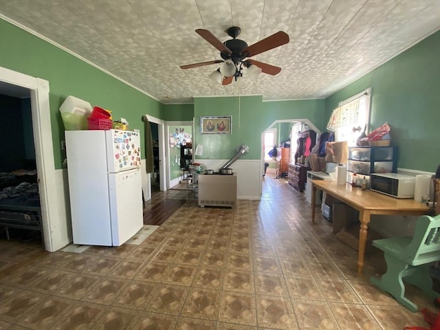 kitchen featuring a ceiling fan, an ornate ceiling, crown molding, and freestanding refrigerator