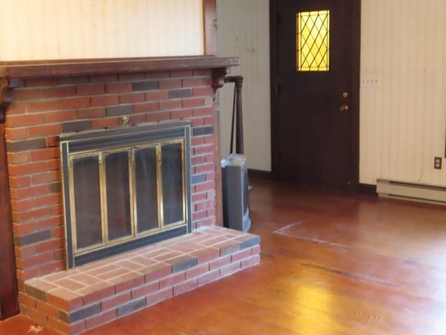 interior details featuring wood finished floors and a brick fireplace