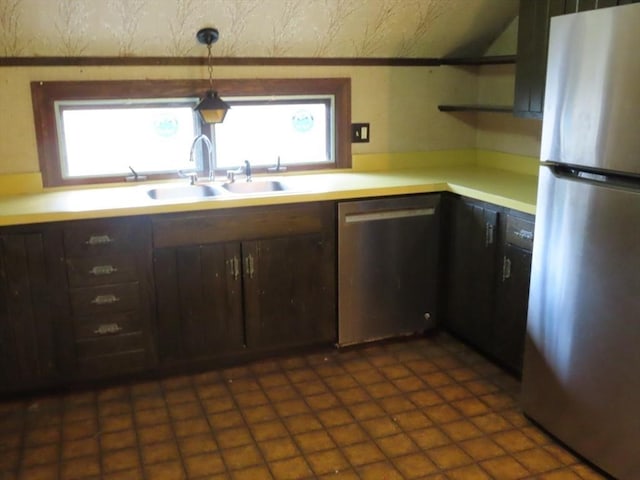 kitchen featuring a sink, open shelves, dark brown cabinetry, light countertops, and appliances with stainless steel finishes