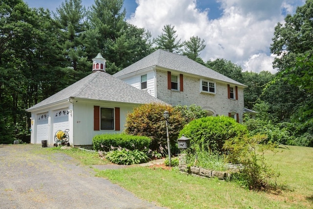 view of front of property featuring a garage and a front lawn