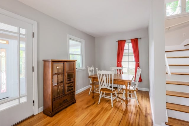 dining space with a healthy amount of sunlight and light hardwood / wood-style flooring