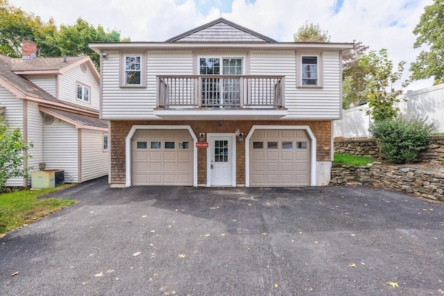 view of front of home featuring a balcony and a garage