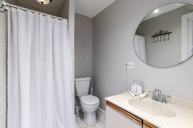 bathroom with vanity, toilet, and tile patterned floors