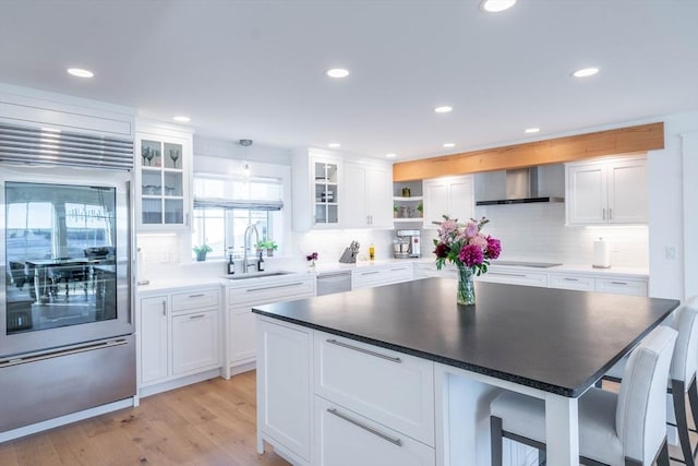61 Chickering Rd, Spencer, MA 01562 - kitchen with appliances with stainless steel finishes, wall chimney exhaust hood, open shelves, a sink, and white cabinetry