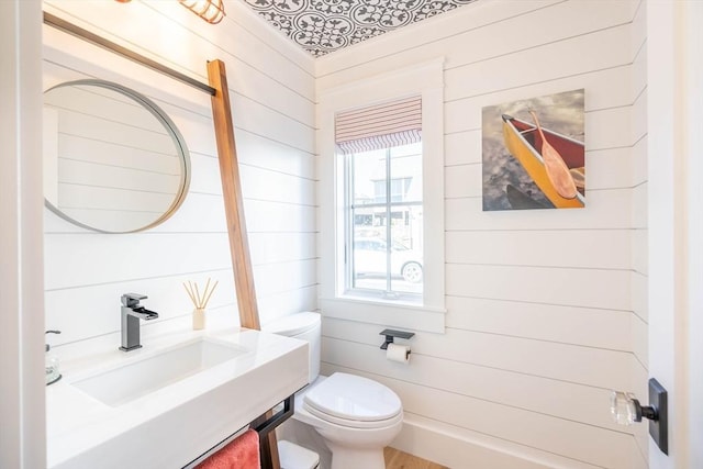 61 Chickering Rd, Spencer, MA 01562 - half bathroom with a sink, toilet, and wood walls