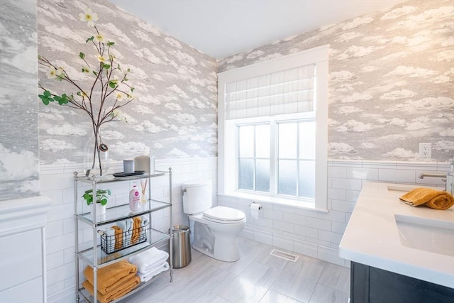 61 Chickering Rd, Spencer, MA 01562 - bathroom with wallpapered walls, a wainscoted wall, tile walls, toilet, and vanity