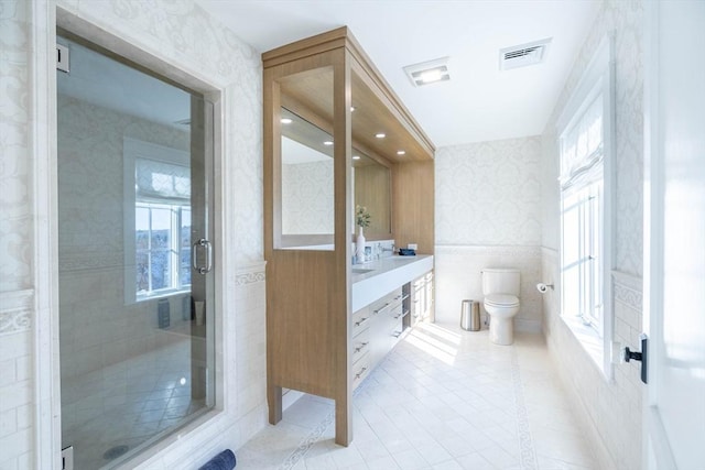 61 Chickering Rd, Spencer, MA 01562 - full bath with wallpapered walls, a wainscoted wall, toilet, healthy amount of natural light, and a shower stall
