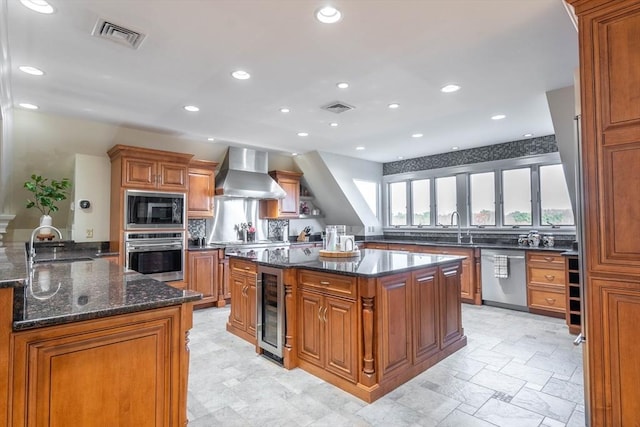61 Chickering Rd, Spencer, MA 01562 - kitchen featuring stainless steel appliances, wall chimney exhaust hood, a sink, brown cabinetry, and recessed lighting