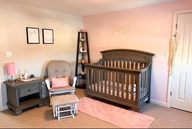 bedroom with a crib and carpet flooring