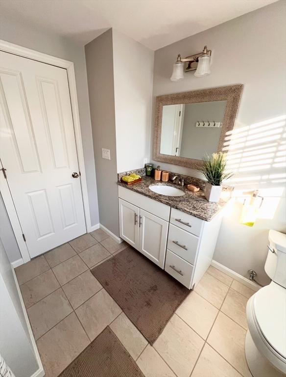 bathroom with vanity, tile patterned floors, and toilet