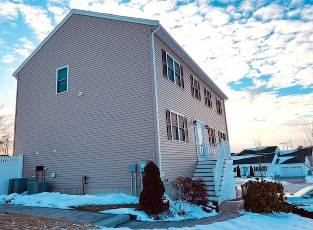 view of snow covered exterior with central air condition unit