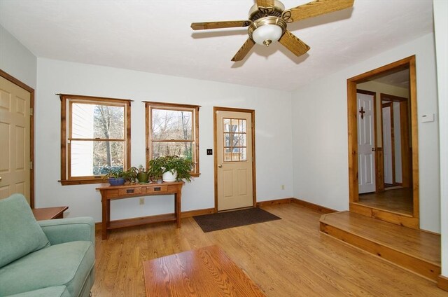 foyer with ceiling fan and light hardwood / wood-style flooring