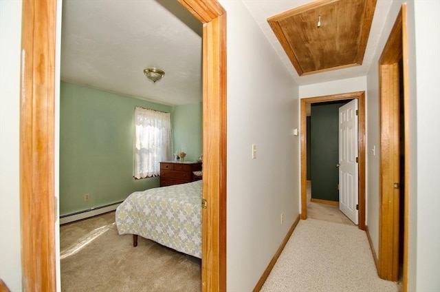 bedroom with baseboard heating, light colored carpet, and wood ceiling