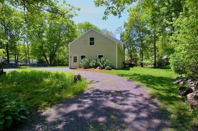 view of property exterior featuring a lawn