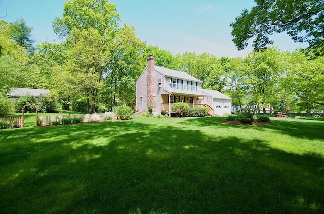 back of house with a lawn and covered porch