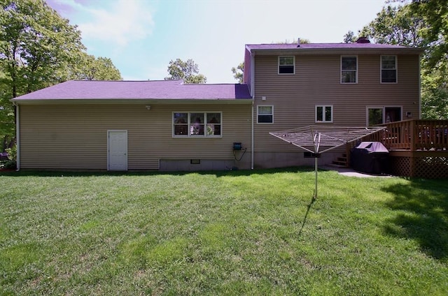 back of property featuring a yard and a deck