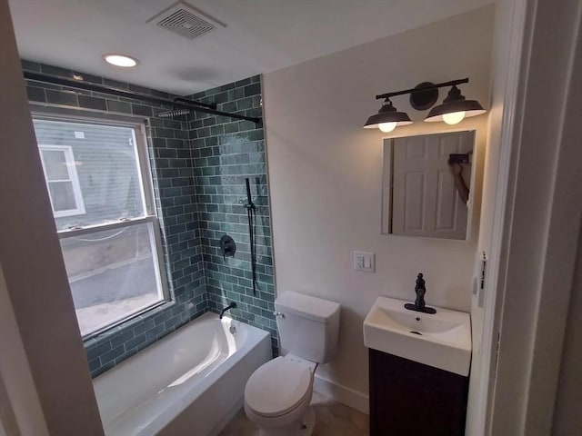 full bathroom featuring vanity, toilet, and tiled shower / bath