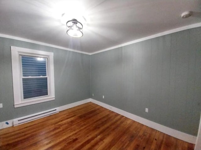 unfurnished room with a baseboard radiator, ornamental molding, and wood-type flooring