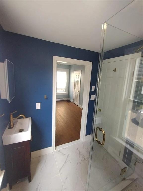 bathroom with vanity and a shower with door